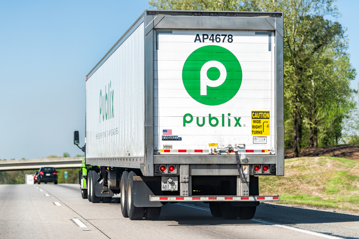 Back of Publix grocery store delivery truck closeup on Georgia highway road with green sign